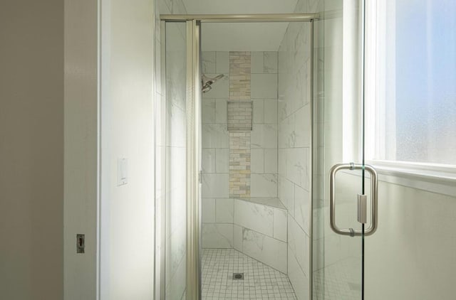 bathroom featuring a shower with door