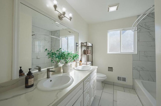 full bathroom featuring a wealth of natural light, toilet, vanity, and tiled shower / bath combo