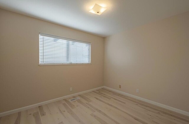 unfurnished room with light hardwood / wood-style floors