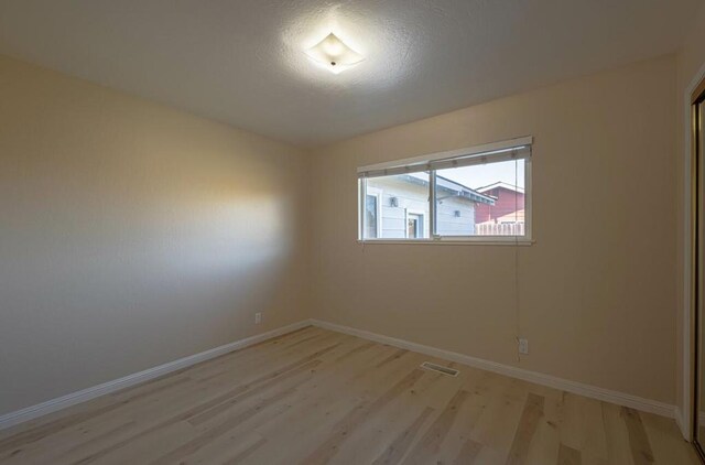 unfurnished room featuring light hardwood / wood-style flooring