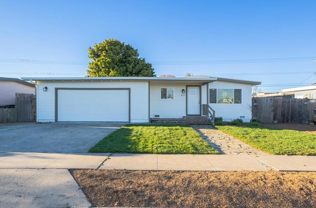 single story home with a garage and a front lawn