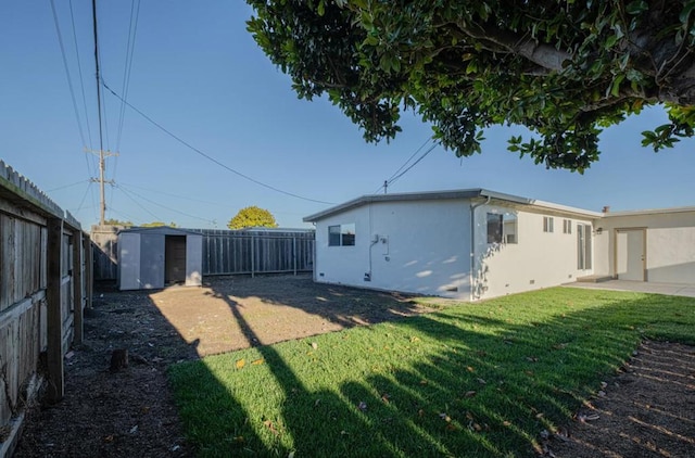 view of side of property with a shed and a yard