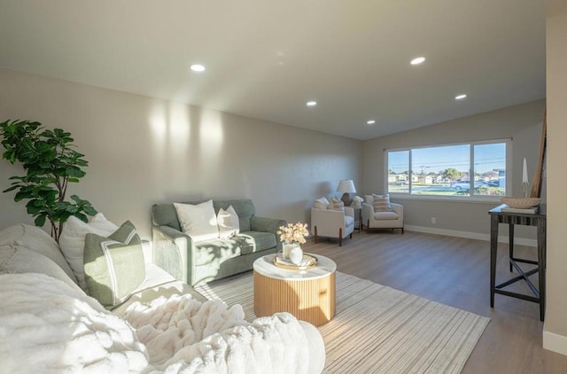 living room with lofted ceiling and light hardwood / wood-style flooring