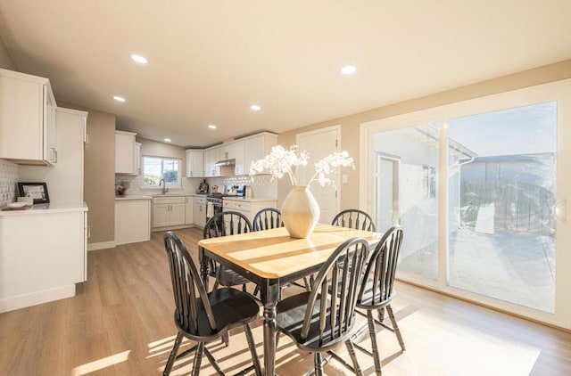 dining space featuring sink and light hardwood / wood-style floors