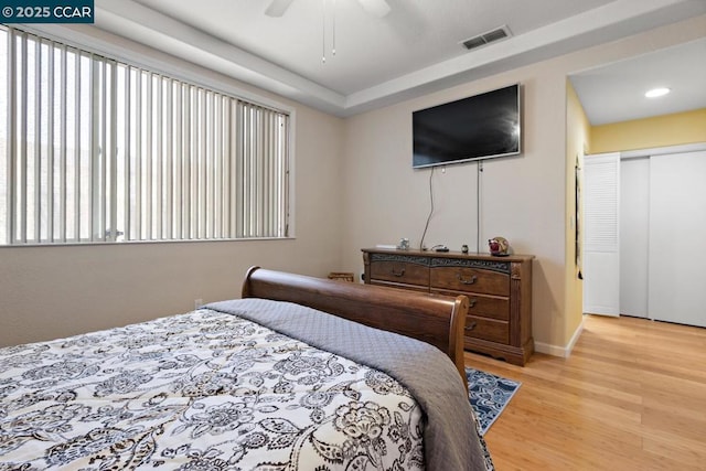 bedroom featuring ceiling fan, a closet, and light hardwood / wood-style floors