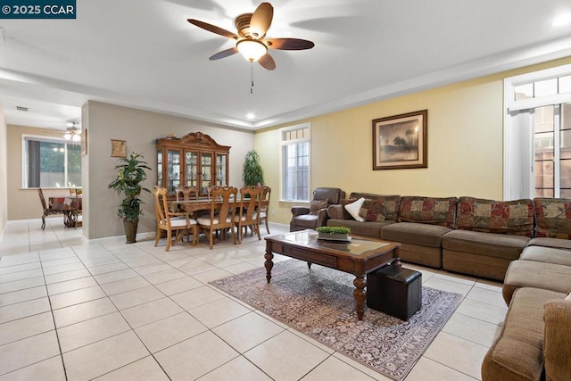 tiled living room with ceiling fan