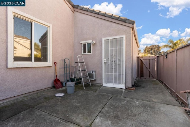 view of exterior entry featuring a patio