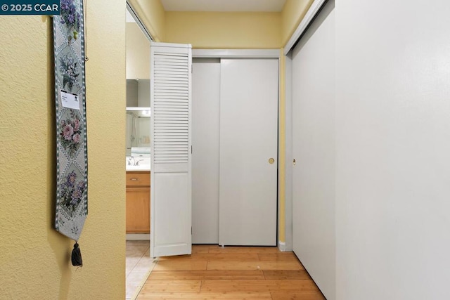 hall featuring sink and light hardwood / wood-style flooring