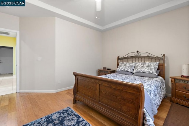 bedroom with ceiling fan and hardwood / wood-style floors