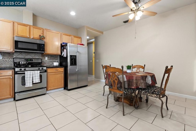 kitchen with decorative backsplash, light tile patterned floors, stainless steel appliances, and ceiling fan