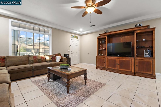 living room with ceiling fan and light tile patterned floors