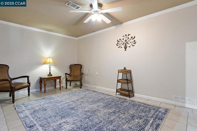 sitting room featuring ceiling fan, light tile patterned flooring, and crown molding