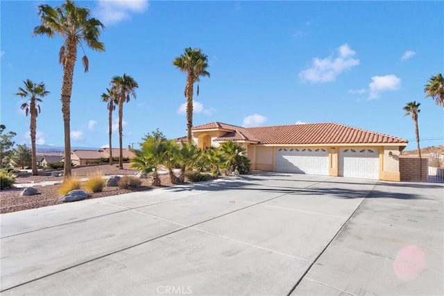 mediterranean / spanish-style home with a garage