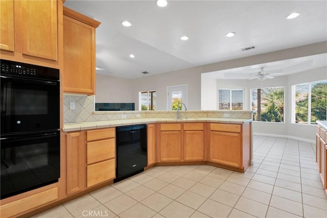 kitchen with kitchen peninsula, ceiling fan, decorative backsplash, black appliances, and sink