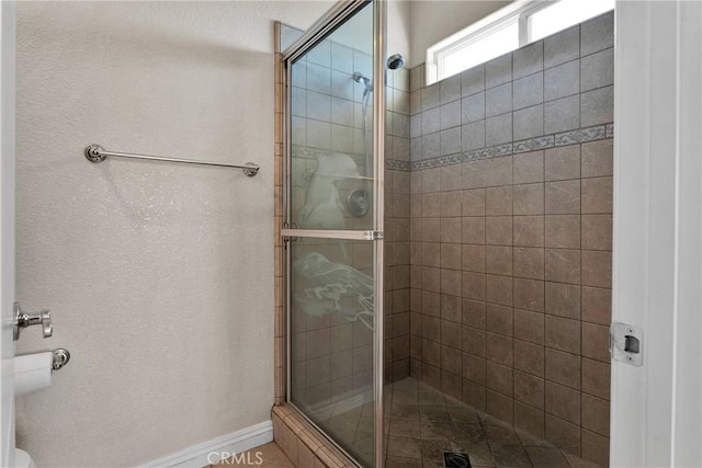 bathroom with a shower with door