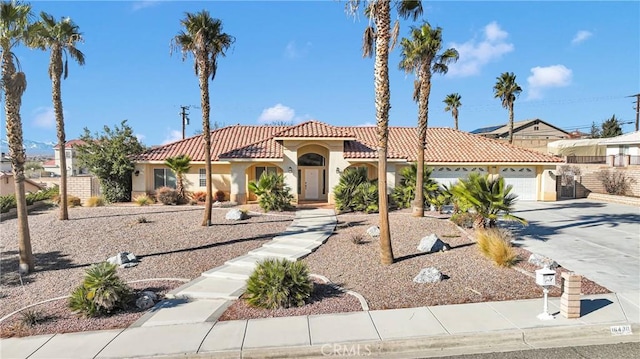 mediterranean / spanish house with a garage