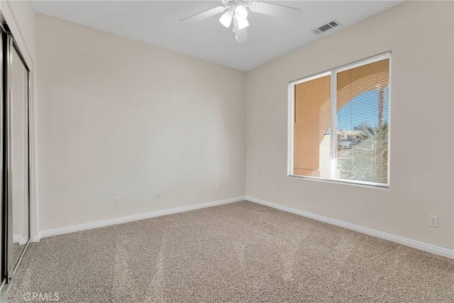 carpeted empty room with ceiling fan