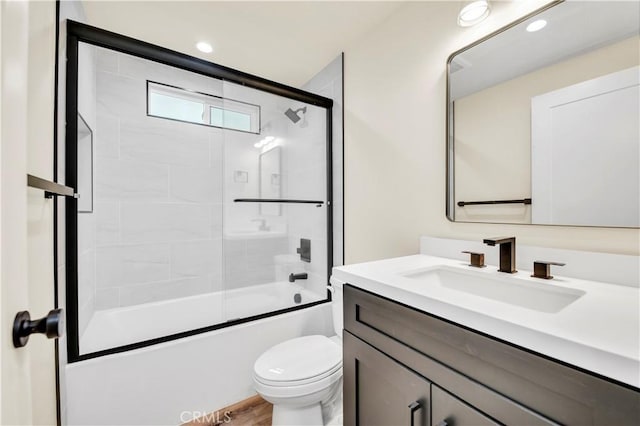 full bathroom with toilet, vanity, and combined bath / shower with glass door