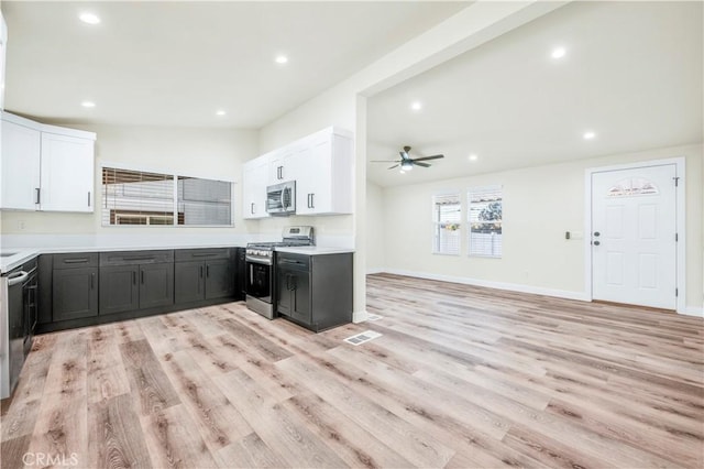 kitchen featuring light wood-type flooring, appliances with stainless steel finishes, and white cabinets