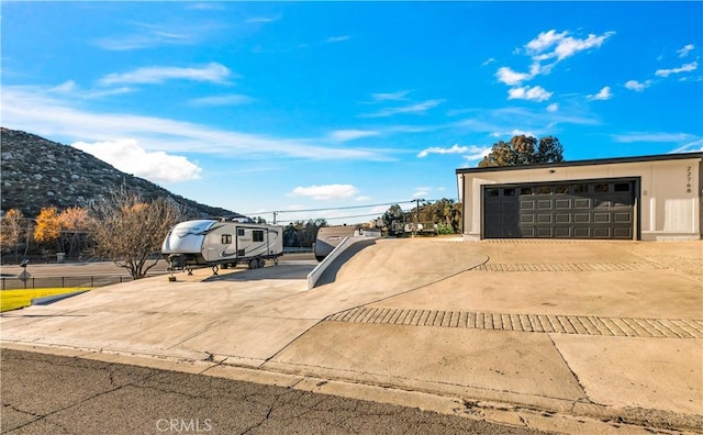 view of front of property featuring a mountain view and a garage