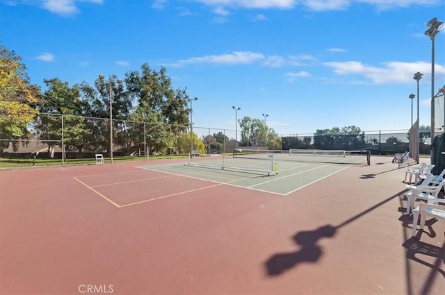 view of tennis court featuring basketball court