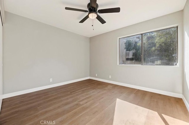 spare room with ceiling fan and hardwood / wood-style flooring