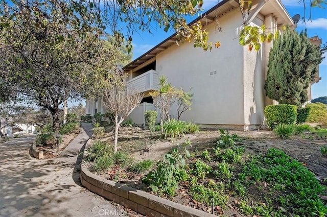 view of side of home with a balcony