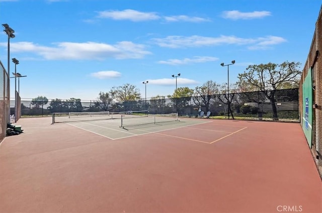 view of tennis court featuring basketball hoop