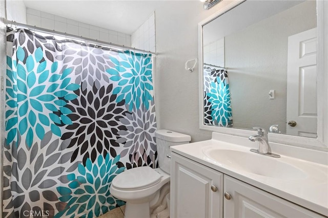 bathroom with toilet and vanity