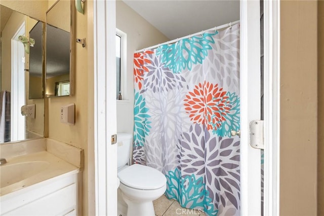 bathroom featuring toilet, vanity, and tile patterned floors