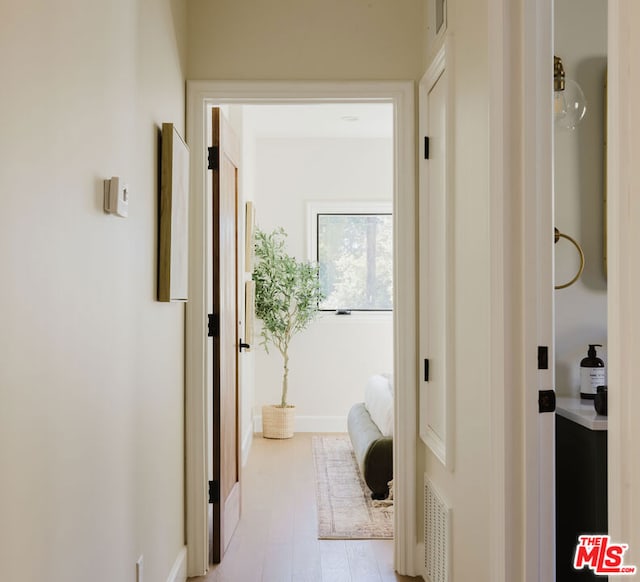 corridor with light wood-type flooring