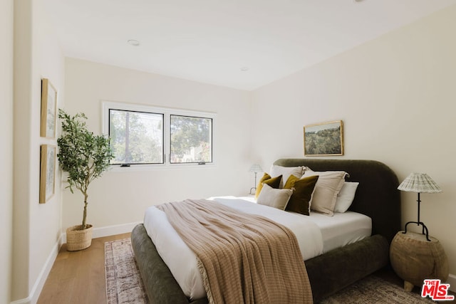 bedroom with hardwood / wood-style floors