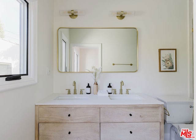 bathroom featuring toilet and vanity