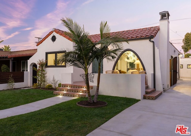 mediterranean / spanish-style home featuring a lawn