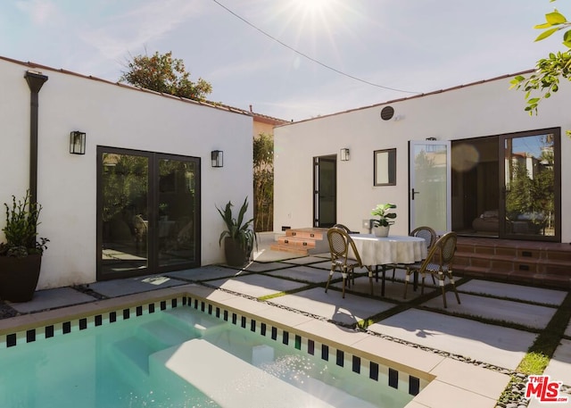 back of property with french doors and a patio