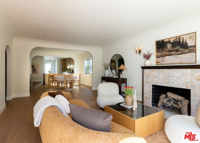 living room featuring dark hardwood / wood-style flooring and a tile fireplace