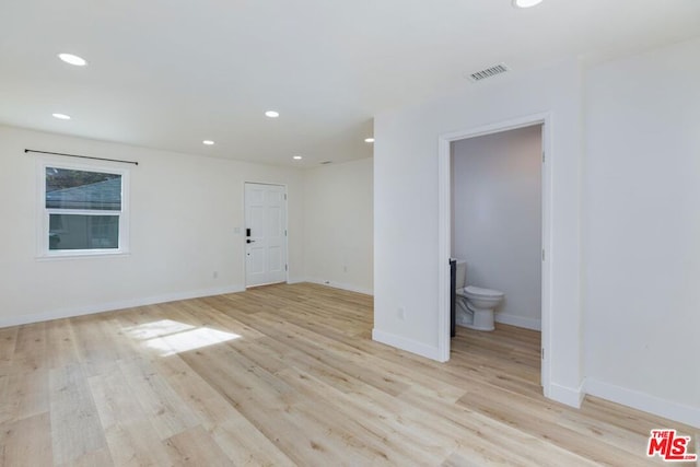 empty room with light hardwood / wood-style flooring