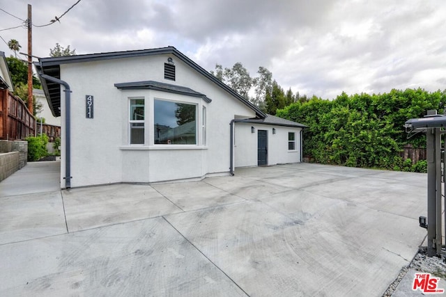 view of side of property with a patio