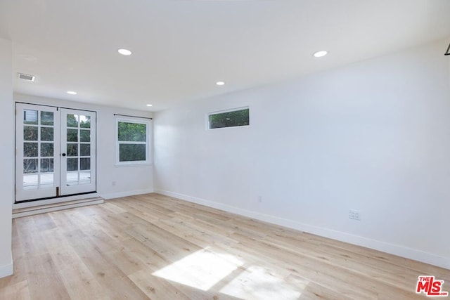 unfurnished room with french doors and light hardwood / wood-style floors