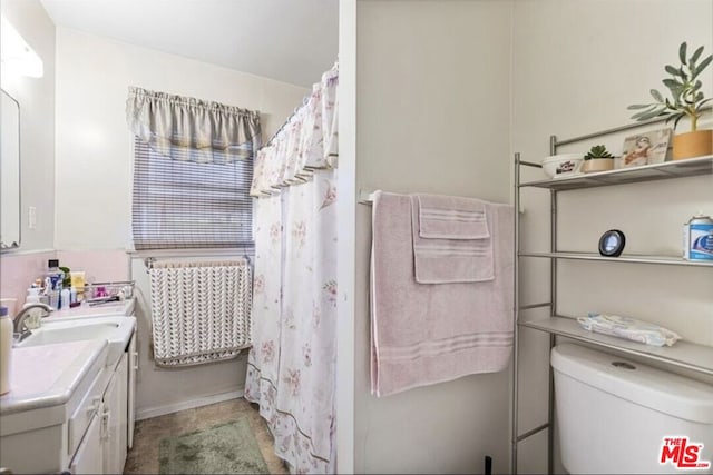 bathroom featuring toilet and vanity