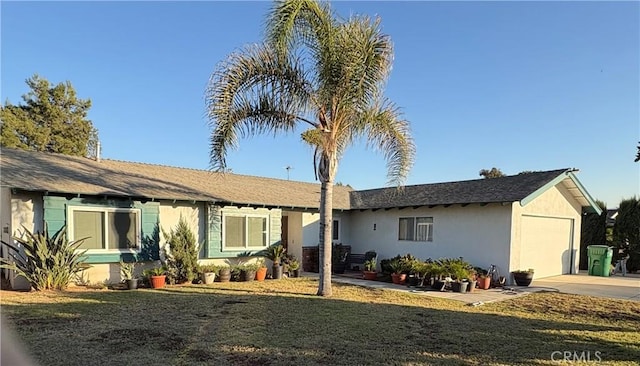 single story home with a garage and a front lawn