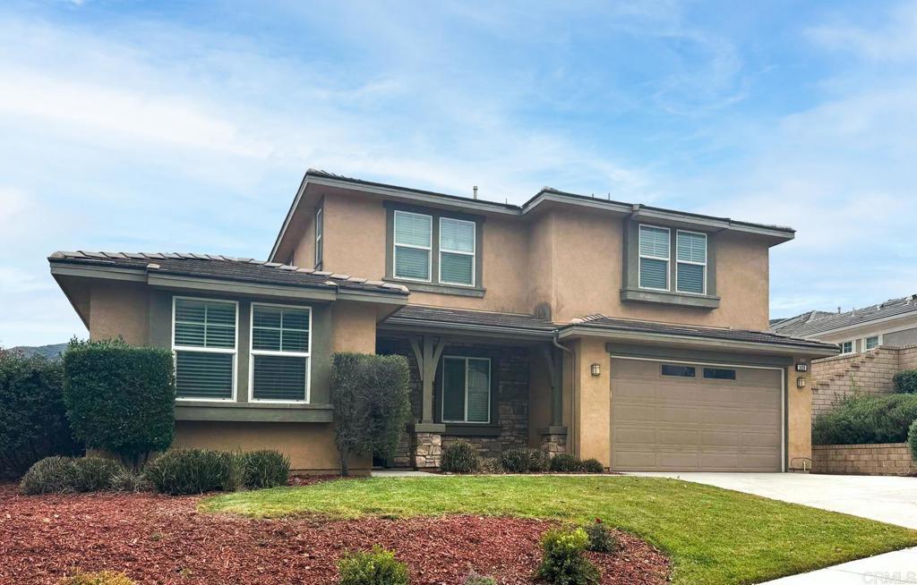 view of front of house with a front lawn and a garage