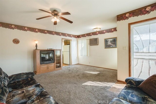 carpeted living room featuring ceiling fan and plenty of natural light