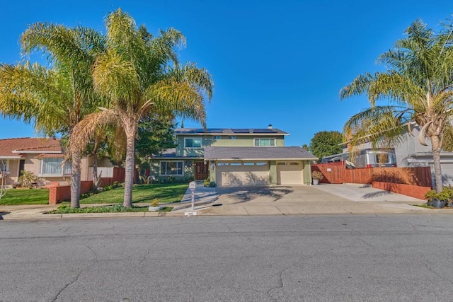 view of front of property with a front lawn and solar panels