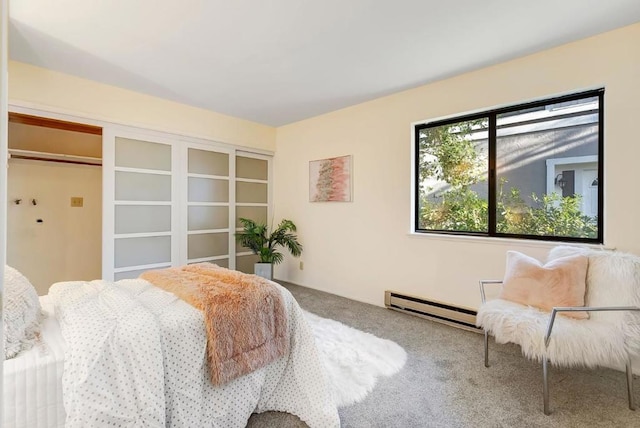 bedroom featuring baseboard heating and carpet floors