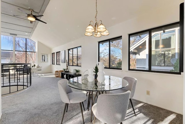 carpeted dining area featuring lofted ceiling and ceiling fan with notable chandelier