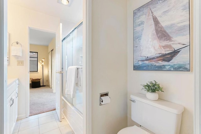 full bathroom featuring toilet, tile patterned floors, vanity, and bath / shower combo with glass door