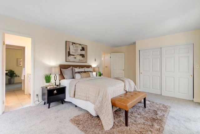 bedroom with light colored carpet and a closet