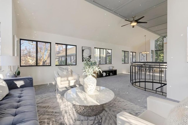 living room featuring ceiling fan with notable chandelier, high vaulted ceiling, and a healthy amount of sunlight