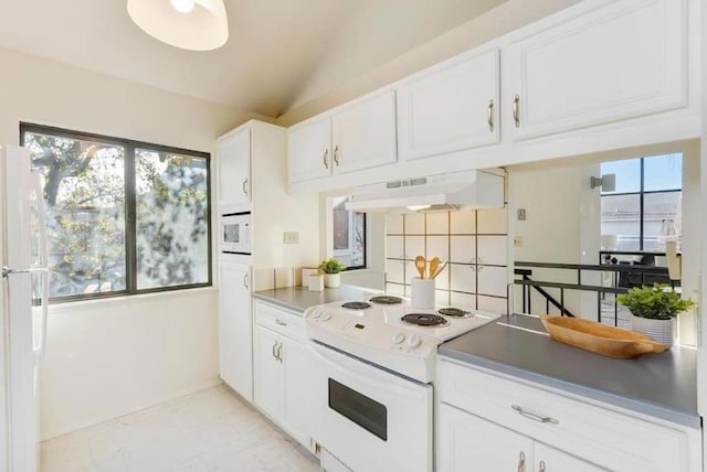 kitchen featuring lofted ceiling, white appliances, white cabinetry, a wealth of natural light, and custom range hood